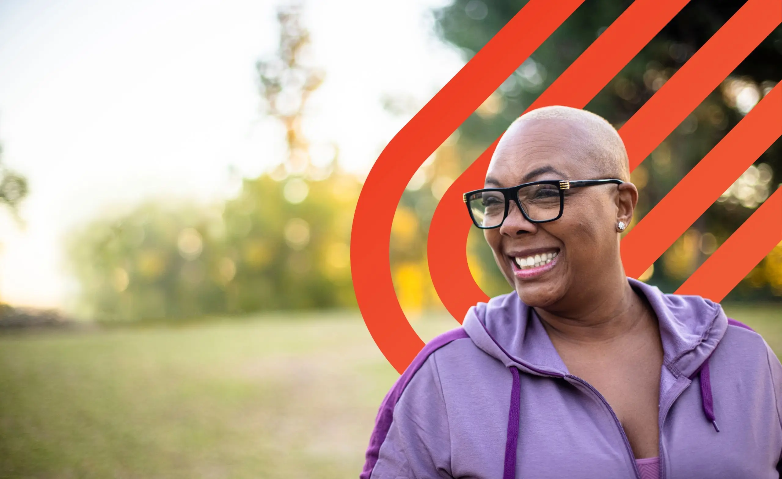 Woman with glasses smiling outdoors