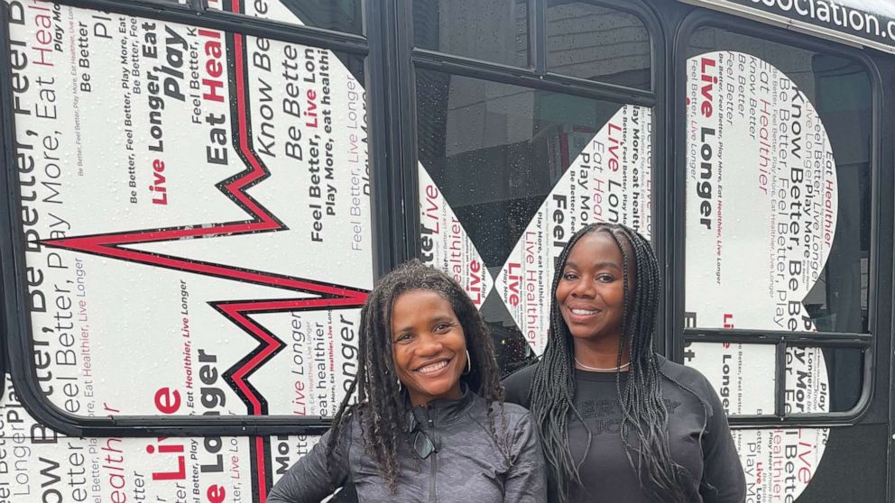 Two women standing next to each other smiling